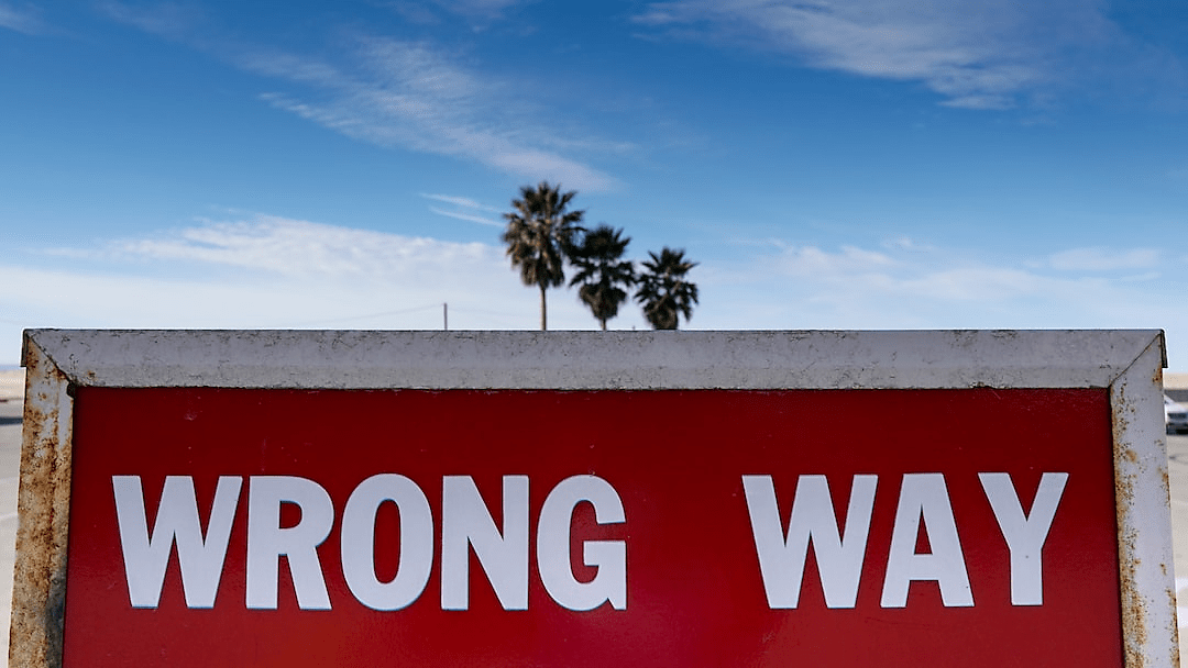 Red sign with text reading "Wrong Way"