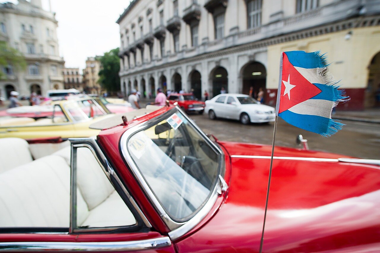 Frayed Cuban flag on car.